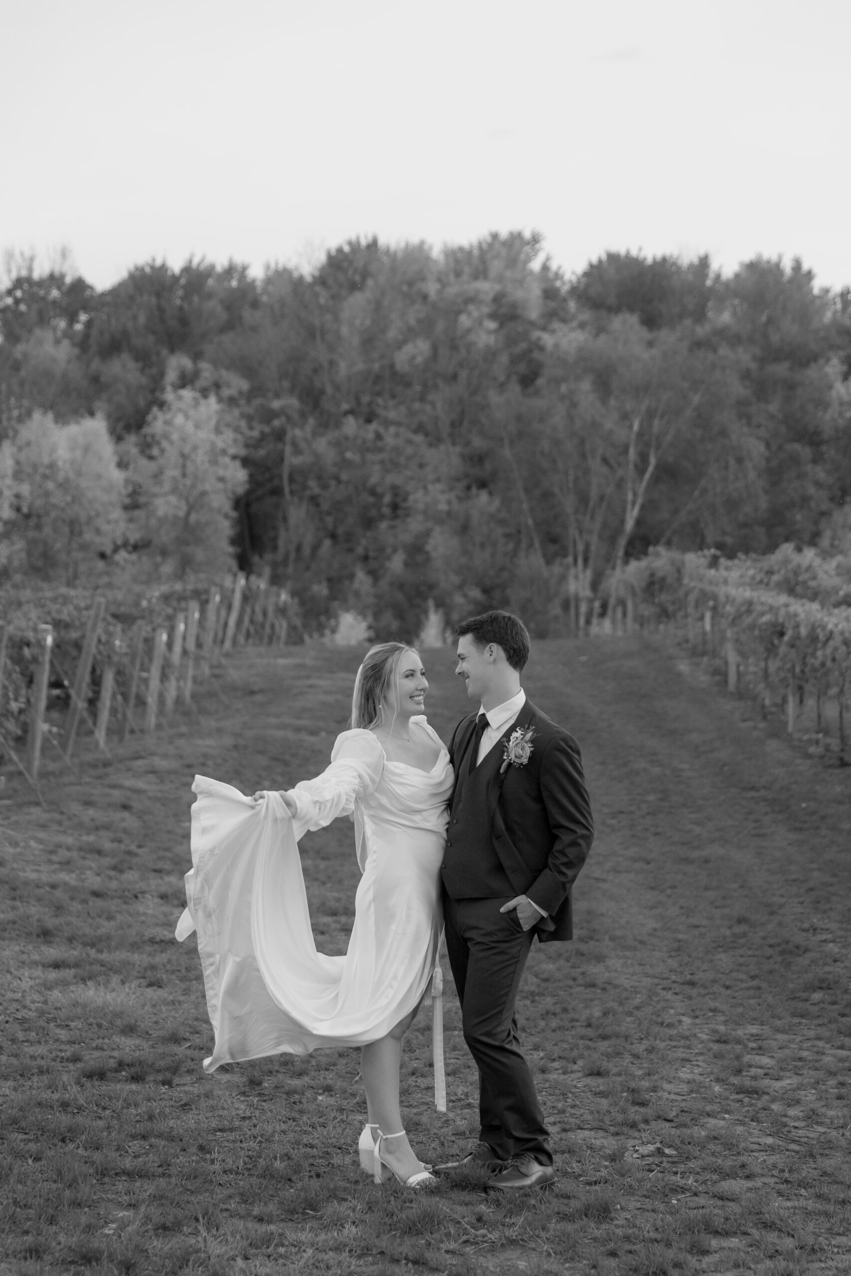 Bride and Groom looking at each other and smiling. It is a vineyard wedding.